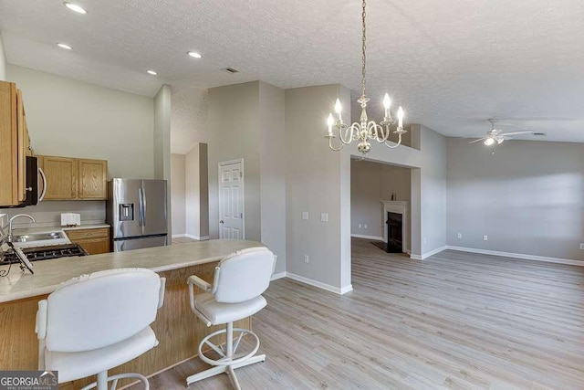 4735 Widgeon Way, Cumming, GA 30028 - kitchen featuring stainless steel appliances, light countertops, a ceiling fan, a peninsula, and a textured ceiling