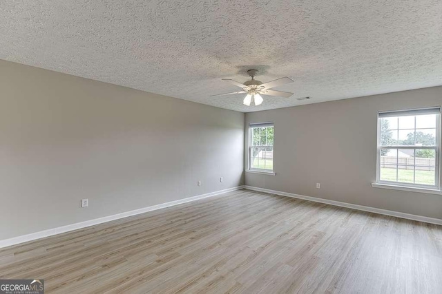 4735 Widgeon Way, Cumming, GA 30028 - empty room featuring light wood-style floors, ceiling fan, and a textured ceiling