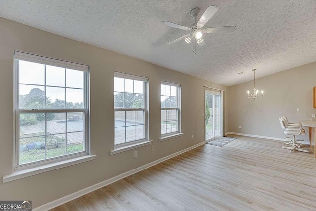 4735 Widgeon Way, Cumming, GA 30028 - interior space with a textured ceiling, a chandelier, plenty of natural light, vaulted ceiling, and wood finished floors
