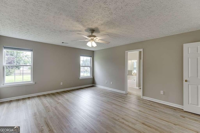 4735 Widgeon Way, Cumming, GA 30028 - unfurnished room featuring light wood-type flooring, a ceiling fan, healthy amount of natural light, and a textured ceiling