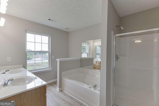 4735 Widgeon Way, Cumming, GA 30028 - full bath with a shower stall, a textured ceiling, wood finished floors, a garden tub, and healthy amount of natural light