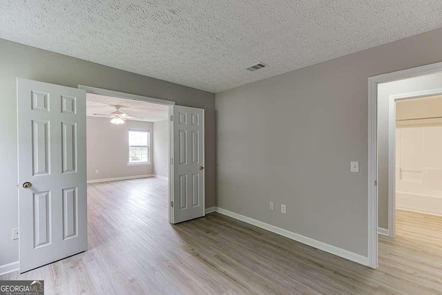 4735 Widgeon Way, Cumming, GA 30028 - unfurnished room featuring light wood-style flooring, a textured ceiling, and a ceiling fan