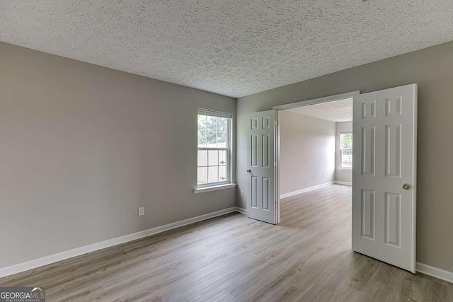 4735 Widgeon Way, Cumming, GA 30028 - spare room featuring wood finished floors and a textured ceiling