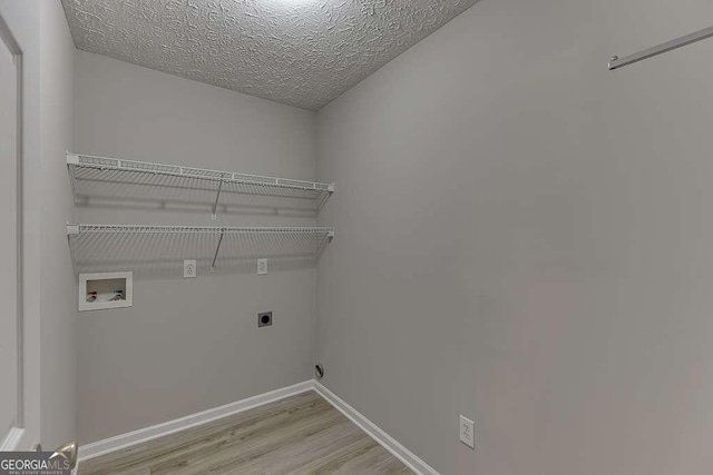 4735 Widgeon Way, Cumming, GA 30028 - laundry room featuring electric dryer hookup, hookup for a washing machine, light wood finished floors, and a textured ceiling