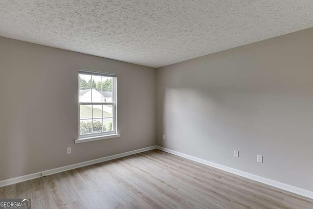 4735 Widgeon Way, Cumming, GA 30028 - unfurnished room with wood finished floors and a textured ceiling