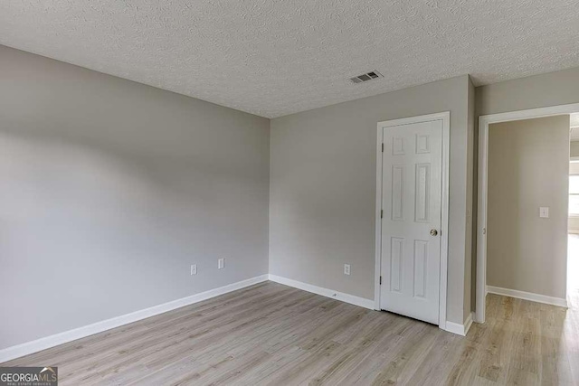 4735 Widgeon Way, Cumming, GA 30028 - unfurnished bedroom with light wood-style flooring and a textured ceiling