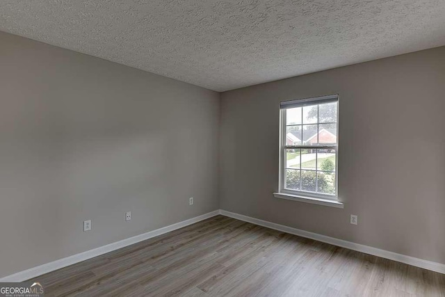 4735 Widgeon Way, Cumming, GA 30028 - empty room featuring wood finished floors and a textured ceiling