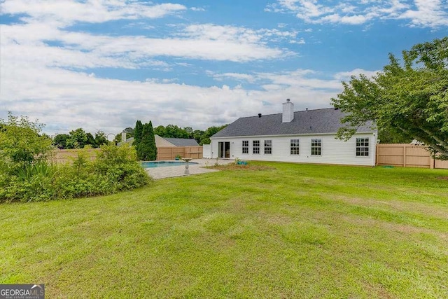 4735 Widgeon Way, Cumming, GA 30028 - rear view of house with a fenced backyard and a chimney