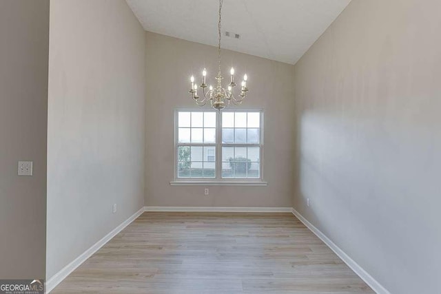 4735 Widgeon Way, Cumming, GA 30028 - empty room featuring a chandelier, lofted ceiling, and light wood-type flooring