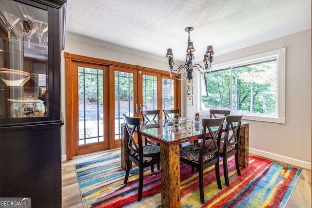 4850 Lake Fjord Pass, Marietta, GA 30068 - dining area featuring a chandelier, a textured ceiling, crown molding, french doors, and wood finished floors