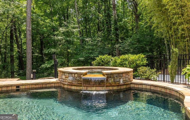 4850 Lake Fjord Pass, Marietta, GA 30068 - view of swimming pool with a pool with connected hot tub and a view of trees