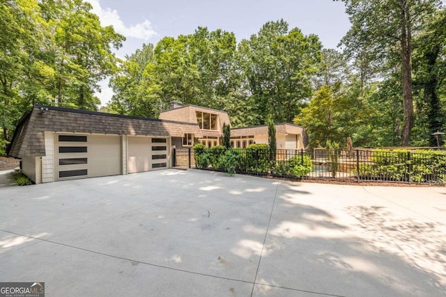 4850 Lake Fjord Pass, Marietta, GA 30068 - view of front of house with a garage, driveway, view of scattered trees, a chimney, and a shingled roof