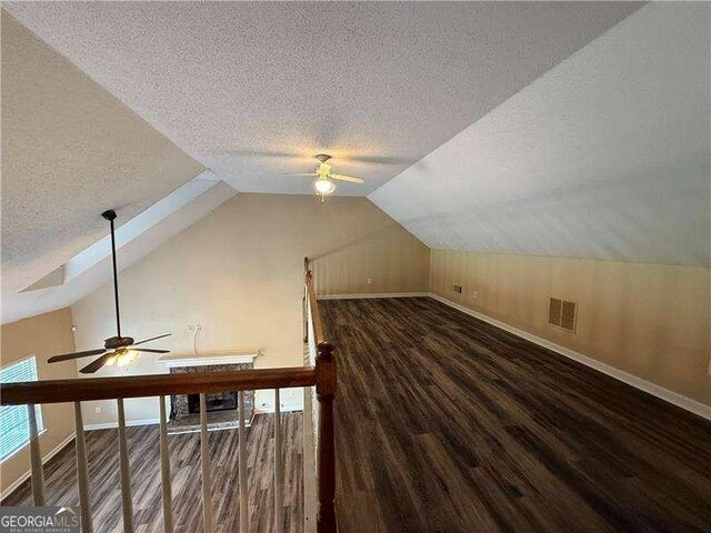 296 Hayes Trce, Hiram, GA 30141 - additional living space featuring a ceiling fan, a textured ceiling, wood finished floors, and vaulted ceiling