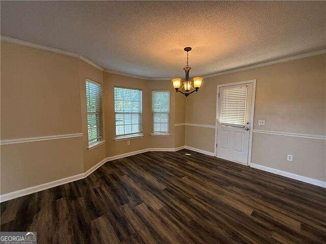 296 Hayes Trce, Hiram, GA 30141 - unfurnished dining area featuring a chandelier, wood finished floors, a textured ceiling, and crown molding