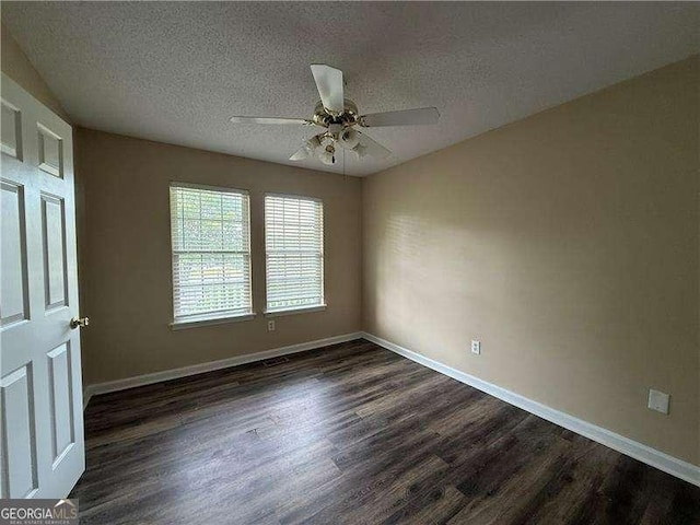 296 Hayes Trce, Hiram, GA 30141 - unfurnished room with dark wood-style flooring, a textured ceiling, and a ceiling fan