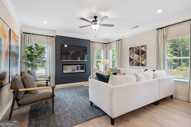 155 Roxeywood Way, Winder, GA 30680 - living room featuring crown molding, healthy amount of natural light, a large fireplace, a ceiling fan, and recessed lighting