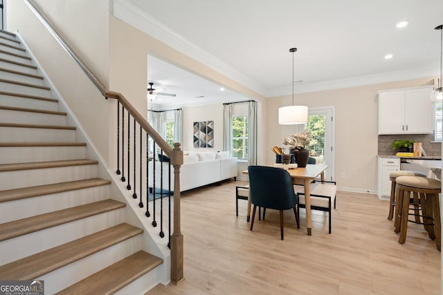 155 Roxeywood Way, Winder, GA 30680 - dining room with ornamental molding, stairway, healthy amount of natural light, light wood finished floors, and a ceiling fan