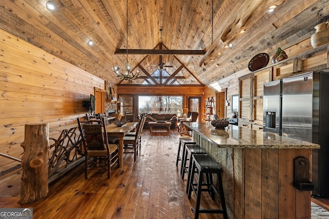 307 Big Timber Rd, Mineral Bluff, GA 30559 - kitchen featuring wooden ceiling, dark wood-style floors, wooden walls, open floor plan, and a kitchen breakfast bar