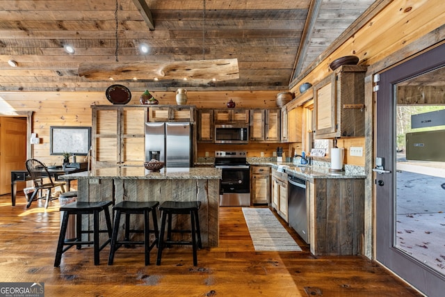 307 Big Timber Rd, Mineral Bluff, GA 30559 - kitchen with stainless steel appliances, a kitchen island, dark wood-style flooring, a wood ceiling with exposed beams, and wooden walls