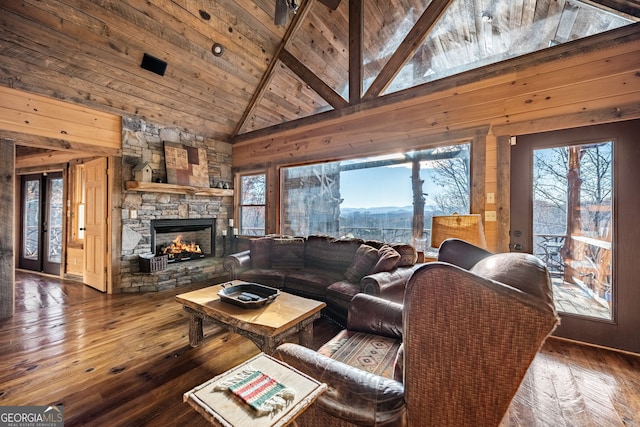 307 Big Timber Rd, Mineral Bluff, GA 30559 - living area featuring plenty of natural light, wood-type flooring, a stone fireplace, a wooden ceiling with exposed beams, and french doors