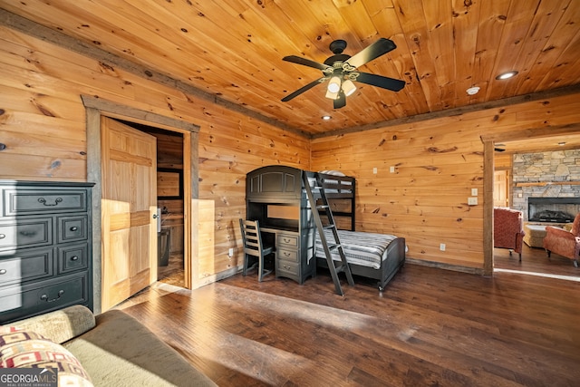 307 Big Timber Rd, Mineral Bluff, GA 30559 - bedroom featuring wood-type flooring, wooden ceiling, wooden walls, a stone fireplace, and recessed lighting