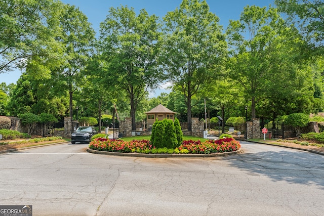 733 Wexford Cove Way, Mableton, GA 30126 - view of asphalt road featuring curbs, street lighting, view of wooded area, and traffic signs