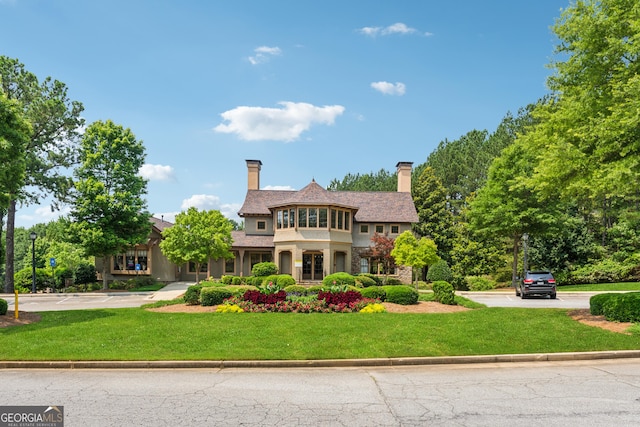 733 Wexford Cove Way, Mableton, GA 30126 - view of front of home with a front lawn, a chimney, and stone siding