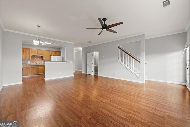 7177 Fringe Flower Dr, Austell, GA 30168 - unfurnished living room featuring ceiling fan, ornamental molding, light wood finished floors, stairs, and arched walkways