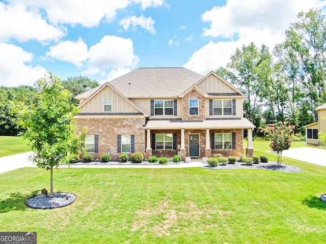 117 Elkins Blvd, Locust Grove, GA 30248 - craftsman-style house featuring a front lawn, brick siding, a porch, and board and batten siding