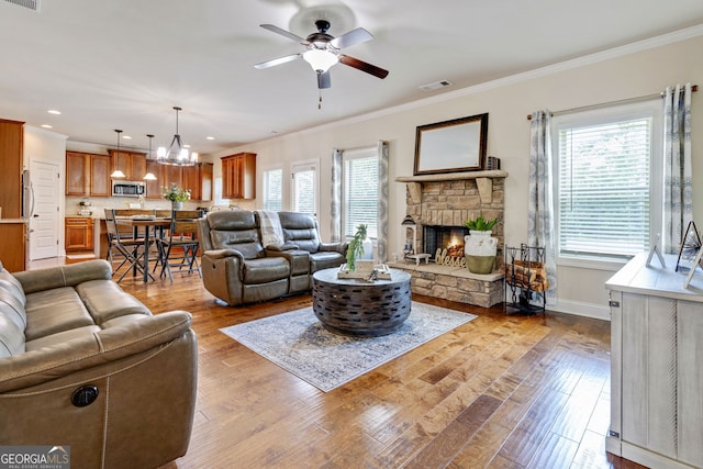 117 Elkins Blvd, Locust Grove, GA 30248 - living room with plenty of natural light, a ceiling fan, ornamental molding, a fireplace, and wood finished floors
