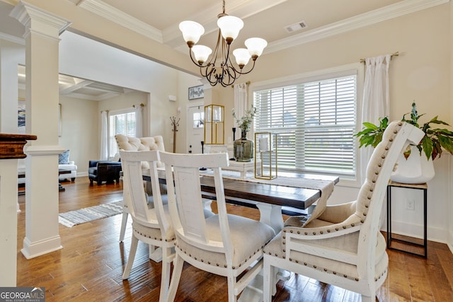 117 Elkins Blvd, Locust Grove, GA 30248 - dining space with a chandelier, hardwood / wood-style floors, crown molding, and ornate columns