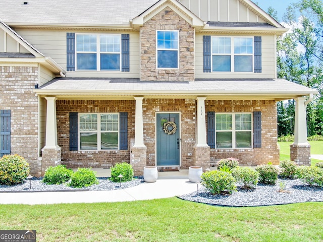 117 Elkins Blvd, Locust Grove, GA 30248 - craftsman-style house featuring board and batten siding, covered porch, brick siding, and a front yard