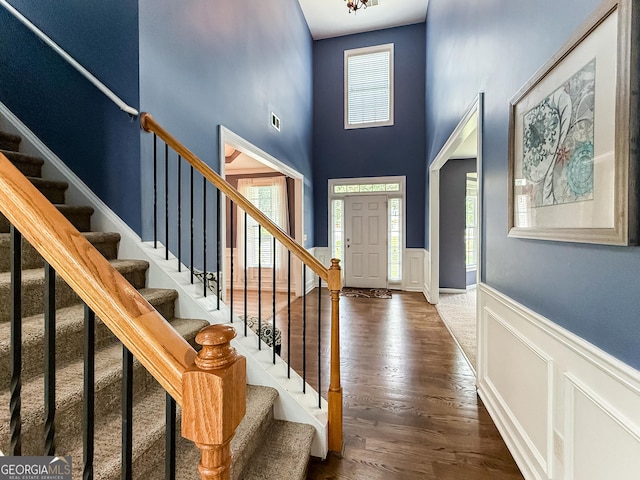 35 Paddle Boat Cv, Senoia, GA 30276 - entryway featuring a wainscoted wall, a decorative wall, stairway, wood finished floors, and a high ceiling