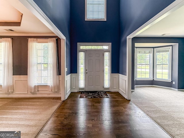 35 Paddle Boat Cv, Senoia, GA 30276 - entrance foyer featuring a wainscoted wall, wood finished floors, a high ceiling, and a decorative wall