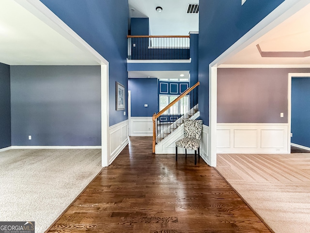 35 Paddle Boat Cv, Senoia, GA 30276 - entrance foyer featuring stairs, wainscoting, ornamental molding, and wood finished floors