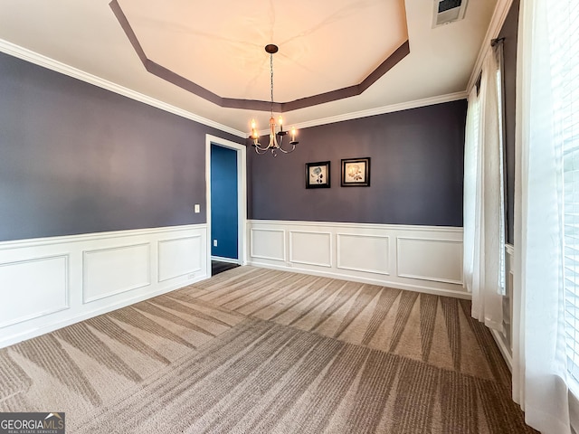 35 Paddle Boat Cv, Senoia, GA 30276 - unfurnished room featuring a raised ceiling, a chandelier, carpet flooring, wainscoting, and healthy amount of natural light