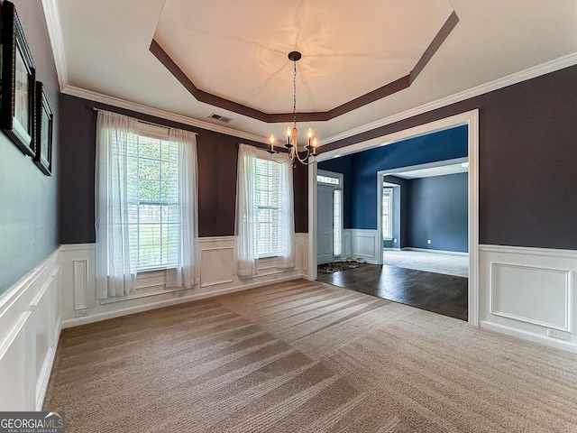35 Paddle Boat Cv, Senoia, GA 30276 - unfurnished dining area with a decorative wall, a chandelier, a tray ceiling, carpet flooring, and a wainscoted wall
