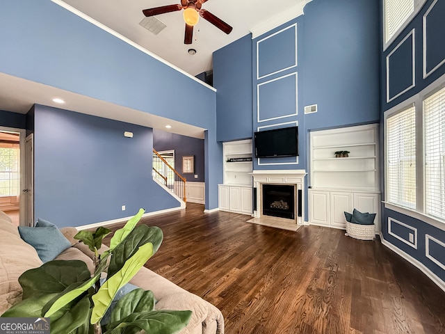 35 Paddle Boat Cv, Senoia, GA 30276 - living area with a high ceiling, a ceiling fan, stairs, a fireplace with flush hearth, and wood finished floors