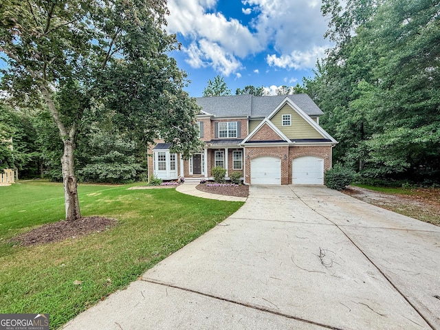 35 Paddle Boat Cv, Senoia, GA 30276 - view of front of property with brick siding, driveway, a front yard, and a garage