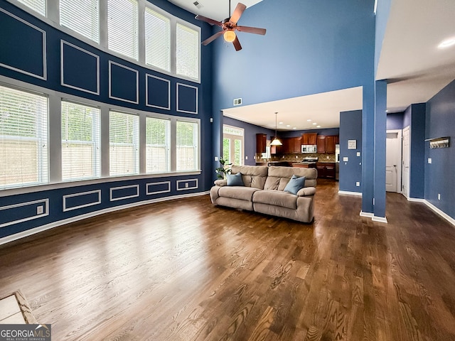35 Paddle Boat Cv, Senoia, GA 30276 - living room featuring a ceiling fan, dark wood-type flooring, and a high ceiling
