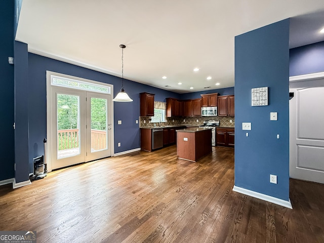 35 Paddle Boat Cv, Senoia, GA 30276 - kitchen with stainless steel appliances, dark wood finished floors, tasteful backsplash, a center island, and hanging light fixtures