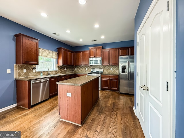 35 Paddle Boat Cv, Senoia, GA 30276 - kitchen featuring appliances with stainless steel finishes, dark wood finished floors, tasteful backsplash, and recessed lighting