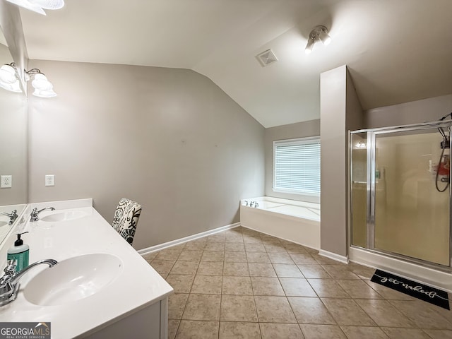 35 Paddle Boat Cv, Senoia, GA 30276 - bathroom with vaulted ceiling, a bath, double vanity, a shower stall, and tile patterned floors