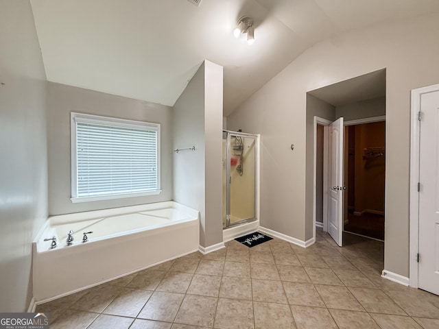 35 Paddle Boat Cv, Senoia, GA 30276 - bathroom with a bath, a shower stall, a spacious closet, lofted ceiling, and tile patterned flooring