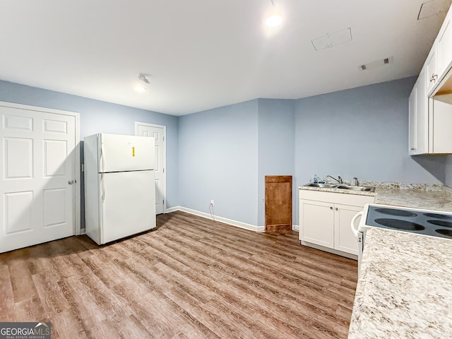 35 Paddle Boat Cv, Senoia, GA 30276 - kitchen featuring white appliances, light wood finished floors, light countertops, and white cabinetry