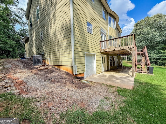 35 Paddle Boat Cv, Senoia, GA 30276 - view of side of home featuring a deck, an attached garage, stairway, and a yard