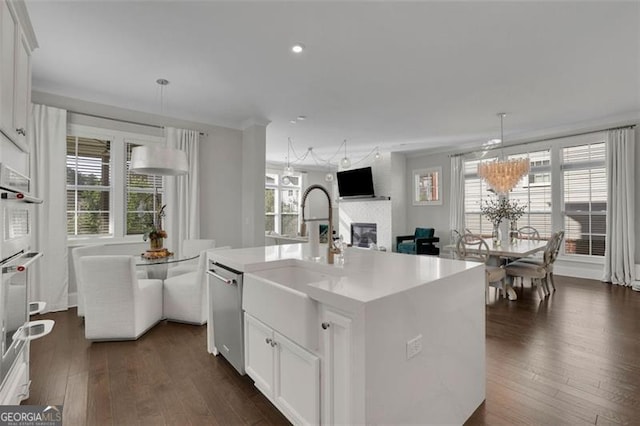 545 Hanlon Way, Alpharetta, GA 30009 - kitchen with appliances with stainless steel finishes, a glass covered fireplace, plenty of natural light, white cabinetry, and recessed lighting