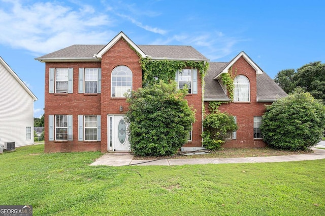 1135 Misty Meadows Way, Hampton, GA 30229 - colonial inspired home featuring brick siding, a front lawn, and a shingled roof