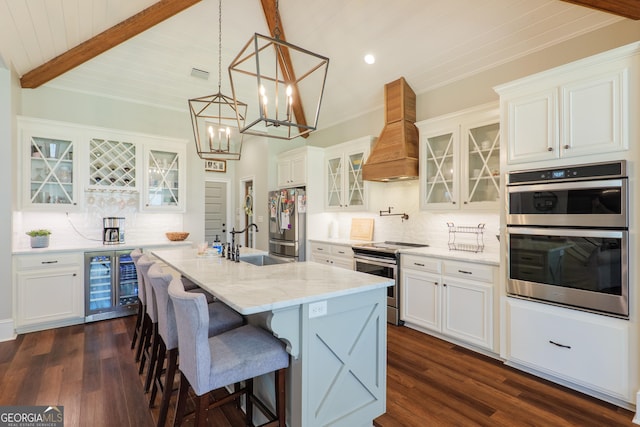 7270 Tillman Branch Rd, Hahira, GA 31632 - kitchen with wine cooler, stainless steel appliances, premium range hood, white cabinets, and a breakfast bar