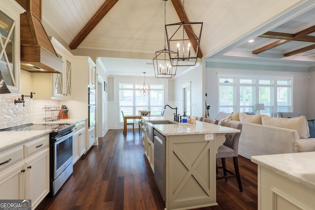 7270 Tillman Branch Rd, Hahira, GA 31632 - kitchen featuring stainless steel appliances, a chandelier, beam ceiling, glass insert cabinets, and light stone countertops
